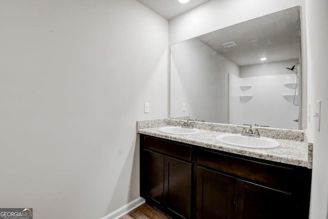 bathroom featuring vanity and a shower