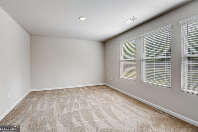 spare room featuring light colored carpet