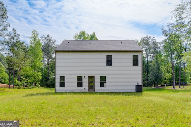 back of house featuring a yard and cooling unit