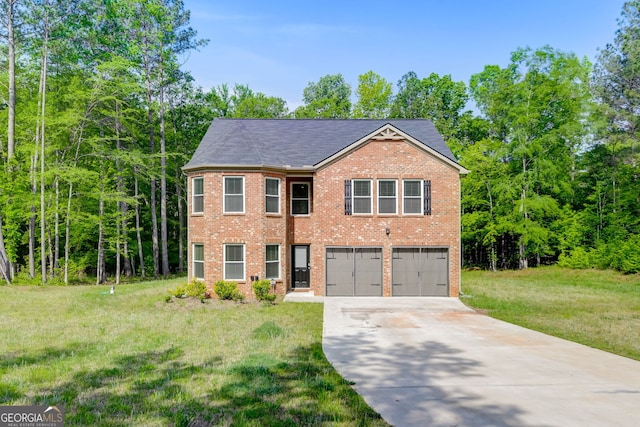 view of front of home with a front yard and a garage