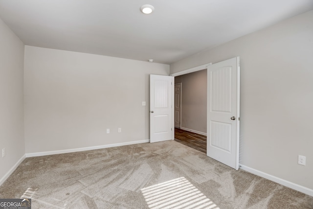 unfurnished bedroom featuring light colored carpet