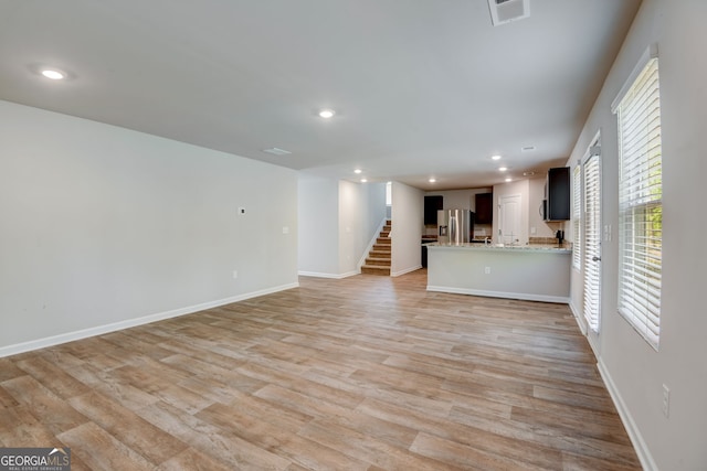 unfurnished living room with light hardwood / wood-style flooring