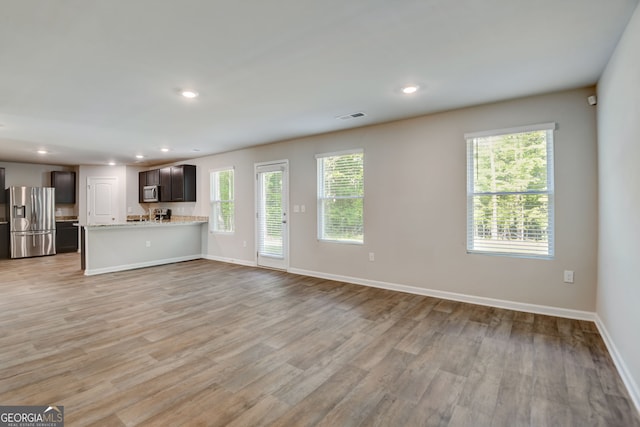 unfurnished living room featuring light wood-type flooring