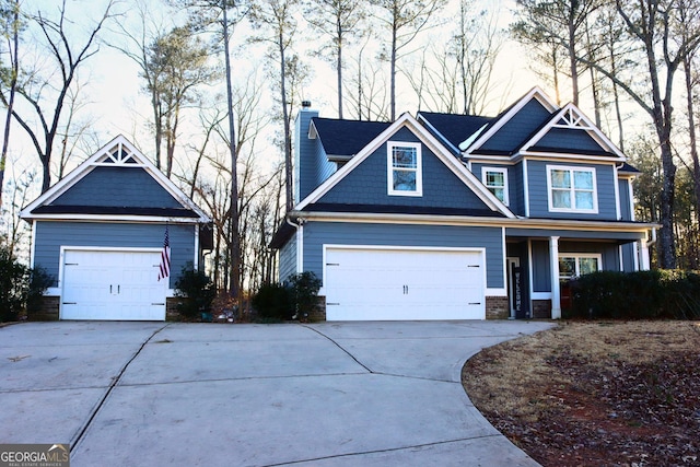 craftsman inspired home featuring a porch and a garage