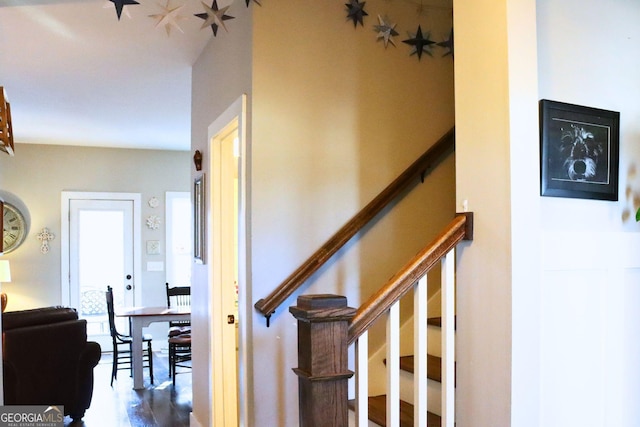 stairway with hardwood / wood-style floors