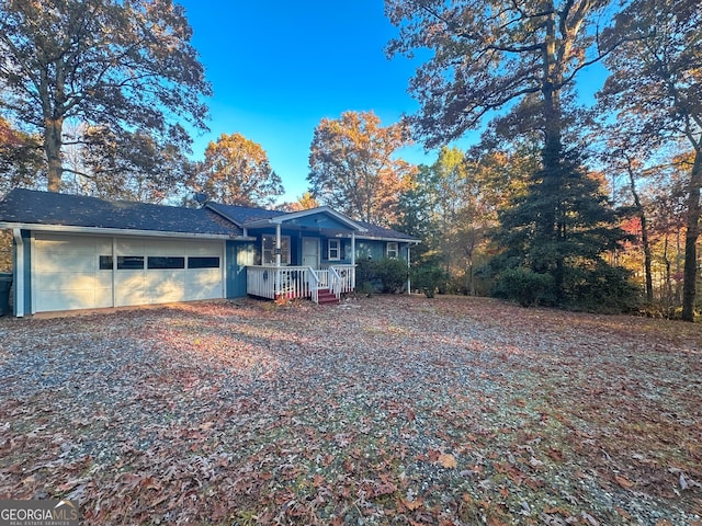 single story home with a porch and a garage