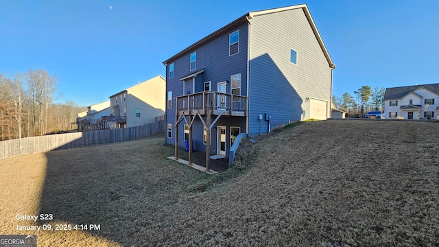 view of home's exterior featuring a wooden deck, a yard, and a garage