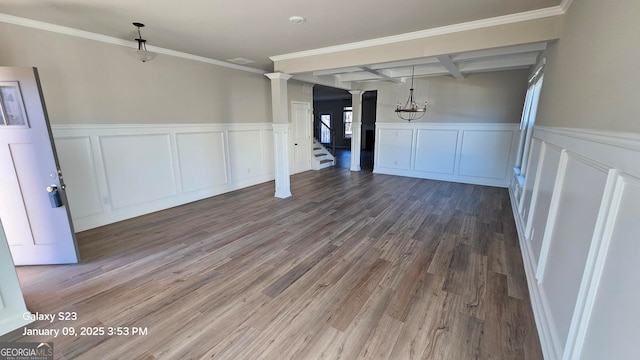 unfurnished dining area with beamed ceiling, ornamental molding, coffered ceiling, and hardwood / wood-style flooring