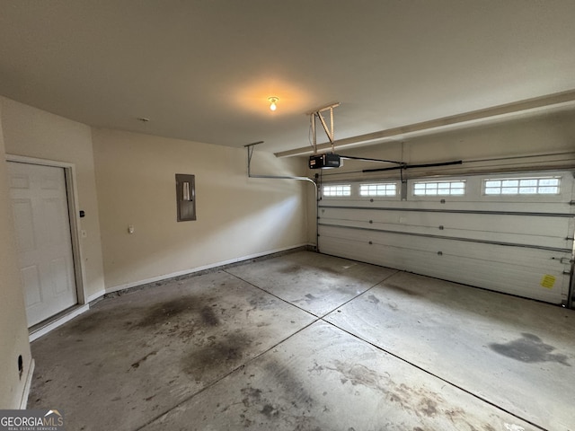 garage with a garage door opener and electric panel