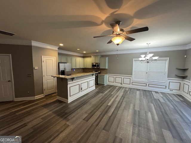 kitchen featuring a center island, hanging light fixtures, appliances with stainless steel finishes, dark wood-type flooring, and ornamental molding