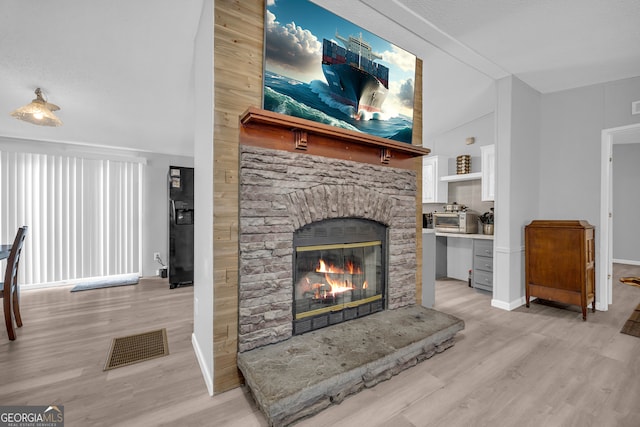 living room featuring a fireplace and light hardwood / wood-style flooring