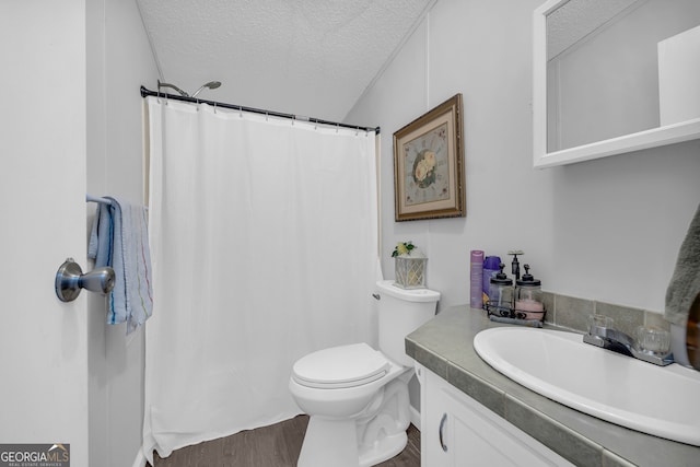 bathroom with vanity, toilet, a textured ceiling, curtained shower, and wood-type flooring