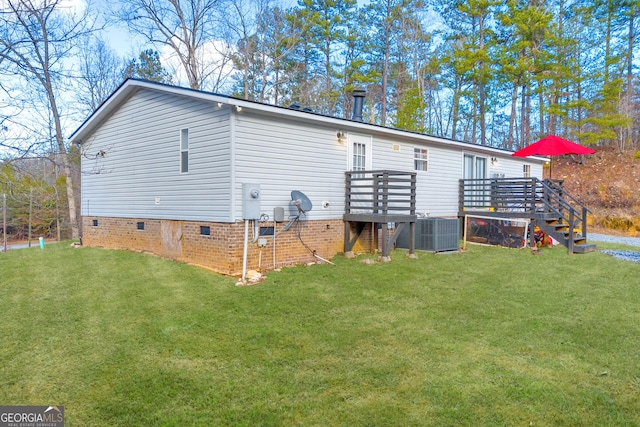 back of house with a yard, cooling unit, and a deck