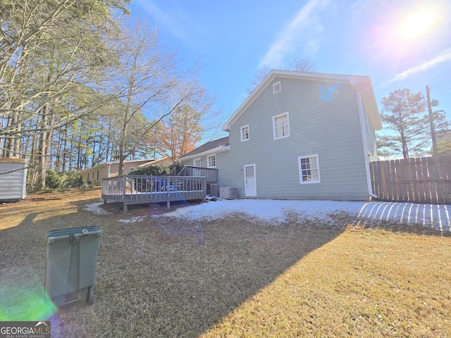 back of house with a lawn, cooling unit, and a wooden deck