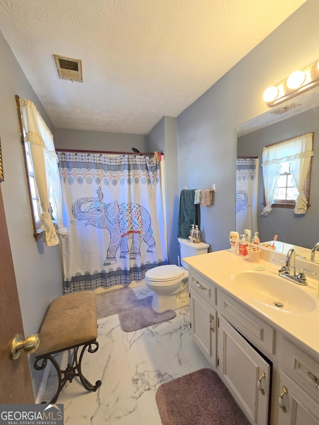 bathroom with vanity, a textured ceiling, toilet, and a shower with shower curtain