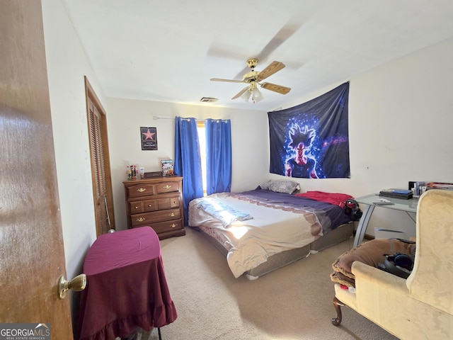 carpeted bedroom with ceiling fan and a closet