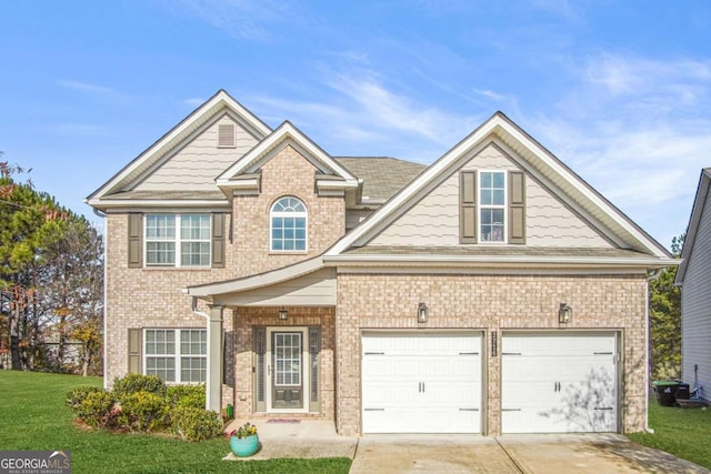 view of front of property featuring a garage and a front lawn