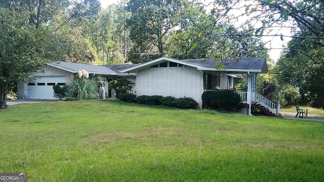 ranch-style house with a porch, a front yard, and a garage