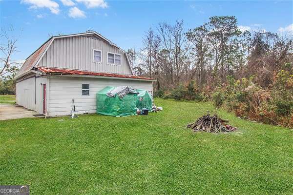 view of side of home featuring a lawn