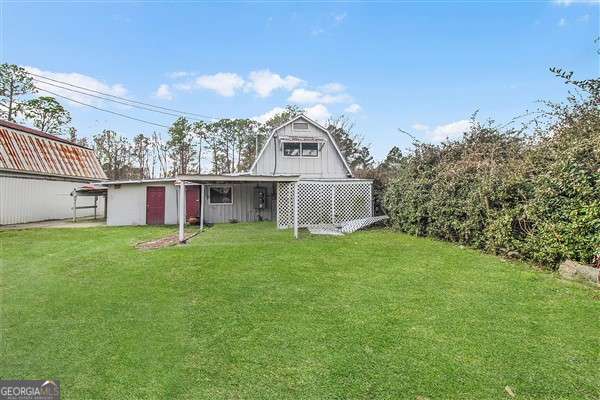 rear view of house with a yard