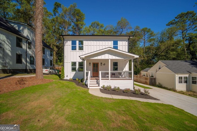 view of front of property with covered porch and a front yard