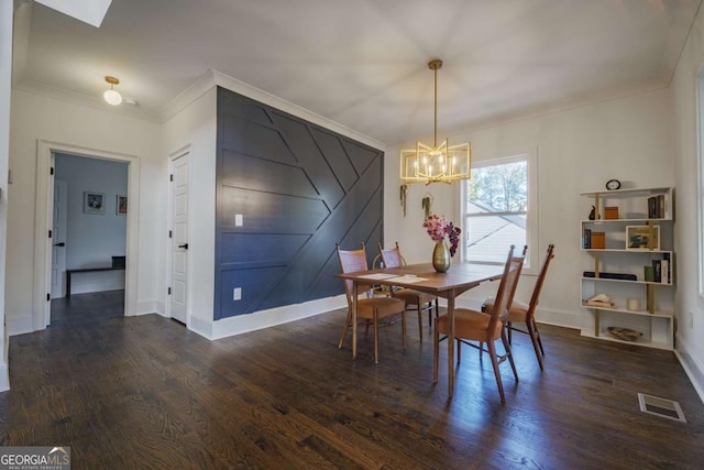 dining room featuring dark hardwood / wood-style flooring, a chandelier, and ornamental molding