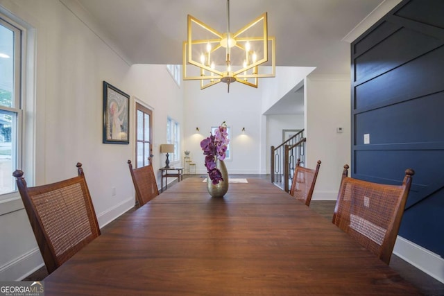 dining space featuring a notable chandelier, crown molding, dark wood-type flooring, and a wealth of natural light