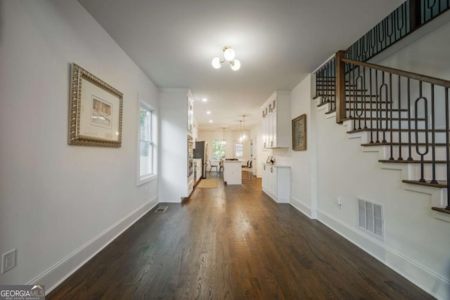 interior space with dark hardwood / wood-style floors and a notable chandelier