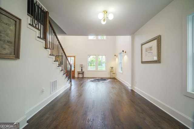 unfurnished living room with dark hardwood / wood-style floors