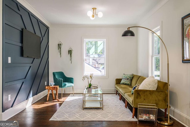 sitting room with wood-type flooring and ornamental molding