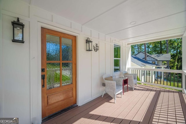 wooden terrace featuring covered porch