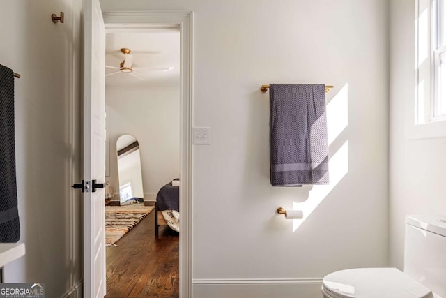 bathroom featuring ceiling fan, hardwood / wood-style floors, and toilet