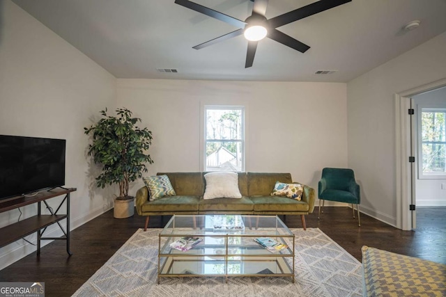 living room featuring ceiling fan, dark hardwood / wood-style flooring, and a wealth of natural light