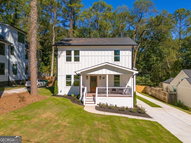 modern farmhouse style home featuring a front lawn and covered porch