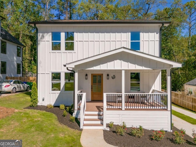 view of front of home with a porch and a front lawn