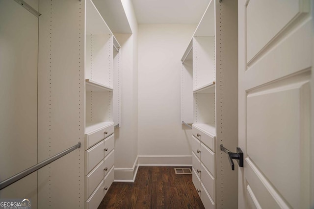 spacious closet with dark wood-type flooring