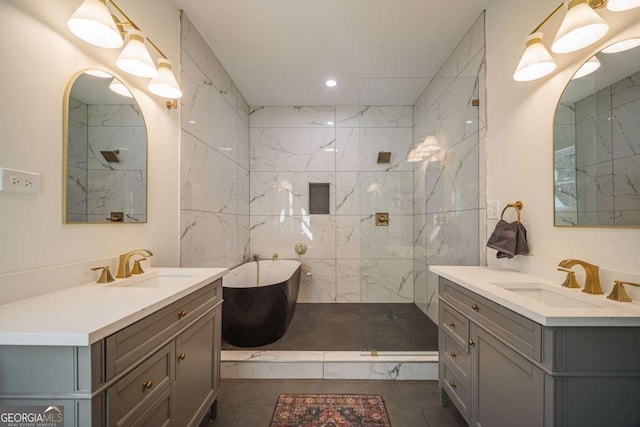 bathroom featuring plus walk in shower, vanity, tile walls, and tile patterned flooring