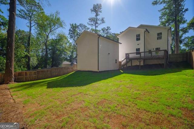 back of property featuring a yard and a deck