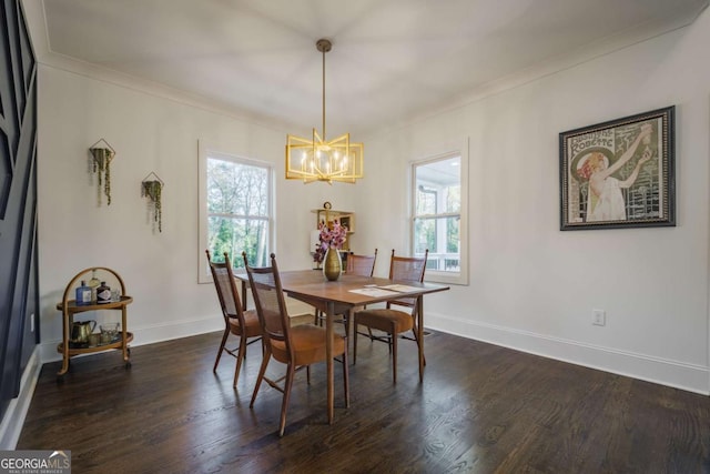 dining space with dark wood-type flooring, crown molding, plenty of natural light, and a notable chandelier