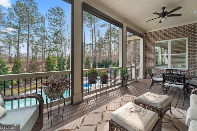 sunroom / solarium featuring ceiling fan