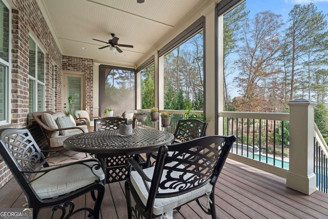 sunroom / solarium featuring a wealth of natural light and ceiling fan