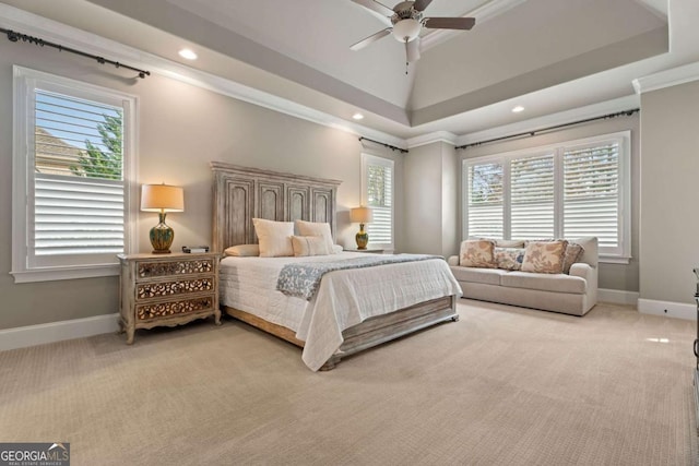 bedroom with carpet floors, a raised ceiling, ceiling fan, and ornamental molding