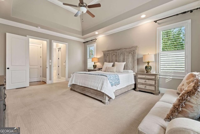 bedroom featuring a tray ceiling, ceiling fan, light colored carpet, and ornamental molding