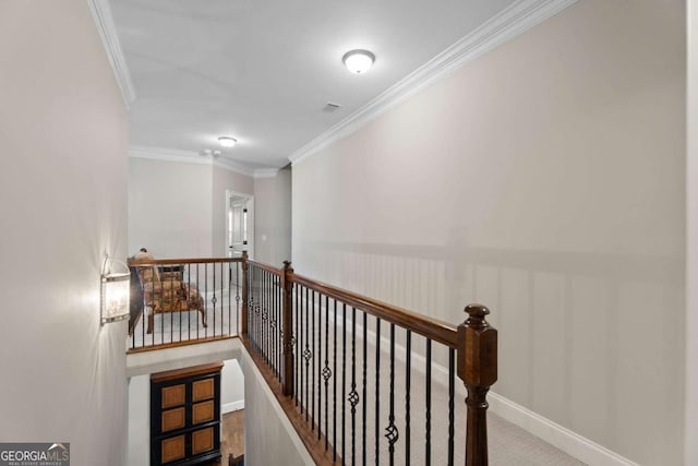 hallway with carpet and crown molding