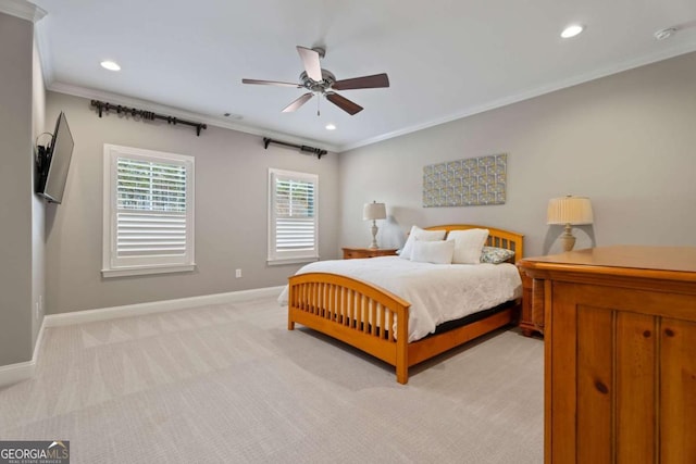 carpeted bedroom with ceiling fan and ornamental molding