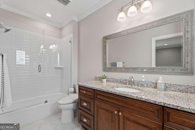 full bathroom with vanity, toilet, crown molding, and enclosed tub / shower combo