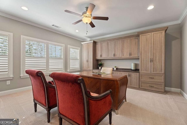 office space featuring ceiling fan, ornamental molding, and light carpet