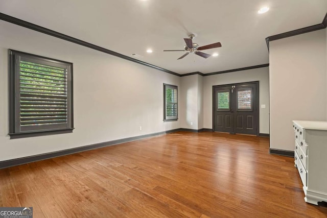 foyer entrance with hardwood / wood-style floors, ceiling fan, and crown molding