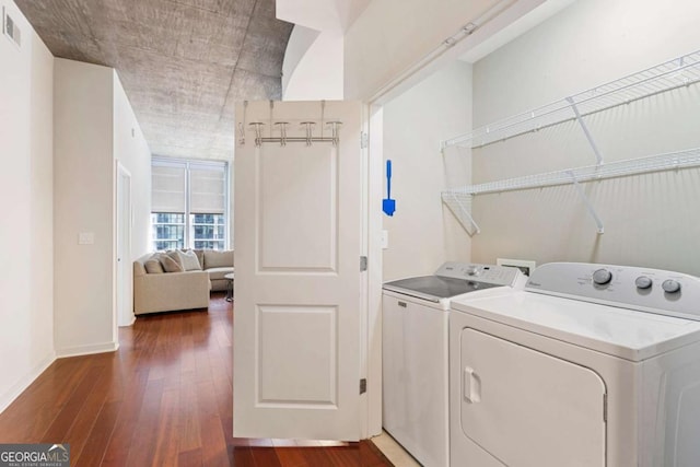 laundry area featuring dark hardwood / wood-style floors and washing machine and dryer