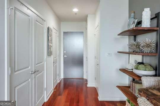 hall with dark hardwood / wood-style flooring